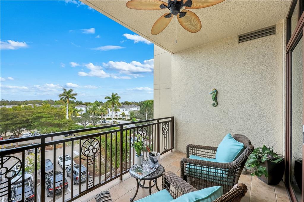 9123 Strada Place, Unit 7309 Naples, FL 34108 - Photo 10 of 48 Balcony featuring a sunroom and a ceiling fan