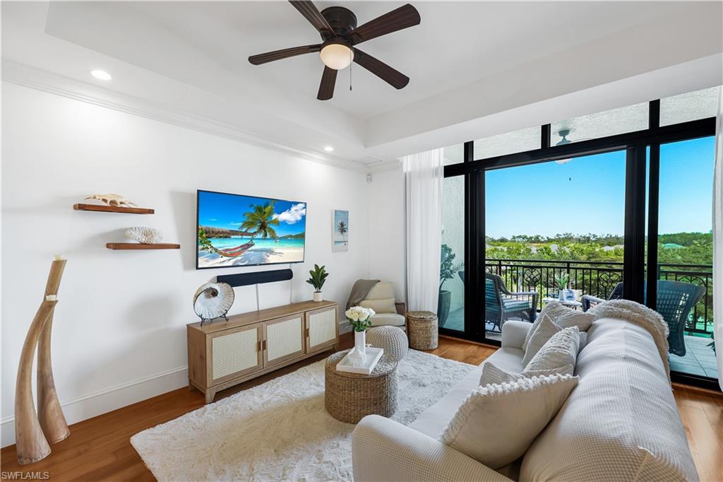 9123 Strada Place, Unit 7309 Naples, FL 34108 - Photo 12 of 46 a living room with furniture and a flat screen tv