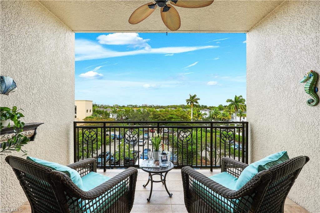 9123 Strada Place, Unit 7309 Naples, FL 34108 - Photo 13 of 46 a balcony with furniture and a potted plant