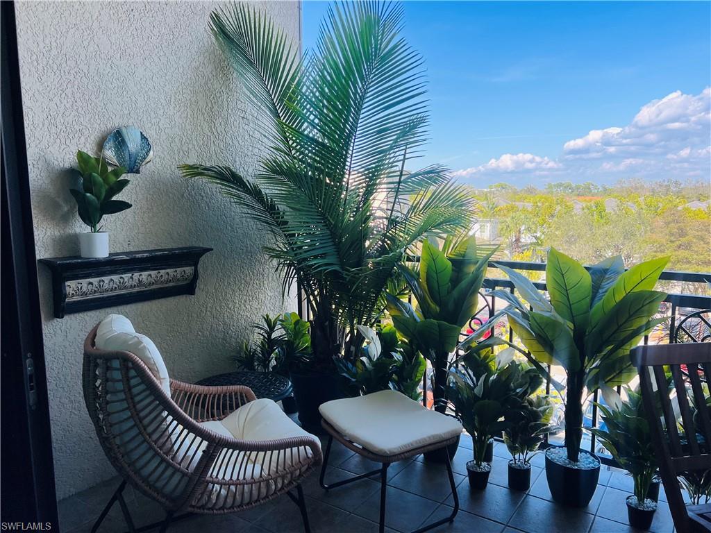9123 Strada Place, Unit 7309 Naples, FL 34108 - Photo 15 of 46 a view of a chair and table in the patio