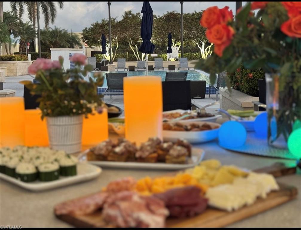 9123 Strada Place, Unit 7309 Naples, FL 34108 - Photo 23 of 48 View of community with a patio, outdoor dining space, and a fire pit