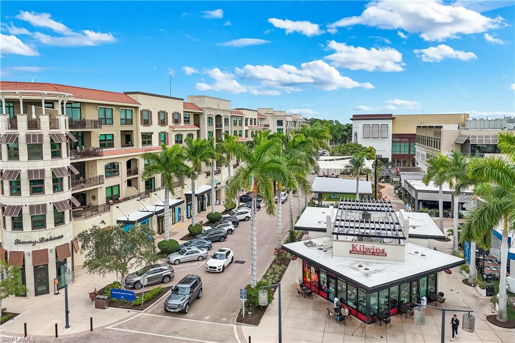 9123 Strada Place, Unit 7309 Naples, FL 34108 - Photo 34 of 46 a view of a building with sitting space and garden view