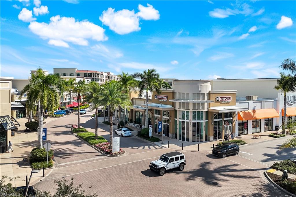 9123 Strada Place, Unit 7309 Naples, FL 34108 - Photo 39 of 46 a view of tall buildings with swimming pool and seating space