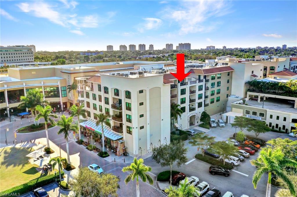 9123 Strada Place, Unit 7309 Naples, FL 34108 - Photo 46 of 48 View of building exterior with a view of skyline and uncovered parking