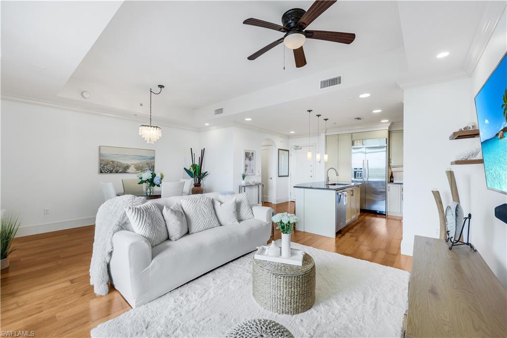 9123 Strada Place, Unit 7309 Naples, FL 34108 - Photo 6 of 48 Living area featuring ornamental molding, light wood-style floors, a ceiling fan, a chandelier, and recessed lighting