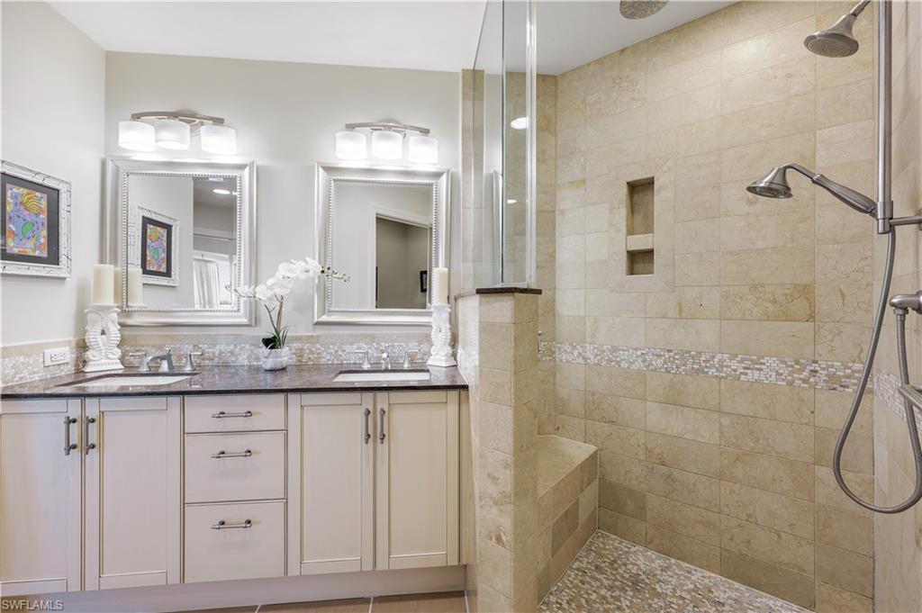 9123 Strada Place, Unit 7309 Naples, FL 34108 - Photo 7 of 46 a bathroom with double sink and a mirror
