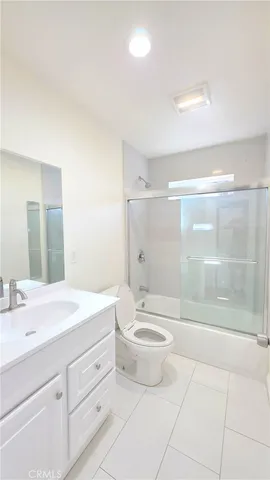 a bathroom with a double vanity sink toilet and shower