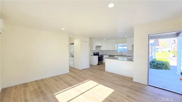 a kitchen with a refrigerator and white cabinets