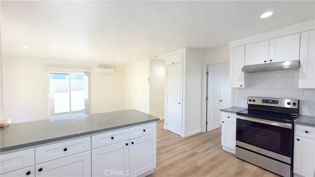 a kitchen with granite countertop a stove and a sink