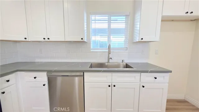a kitchen with appliances cabinets and a sink