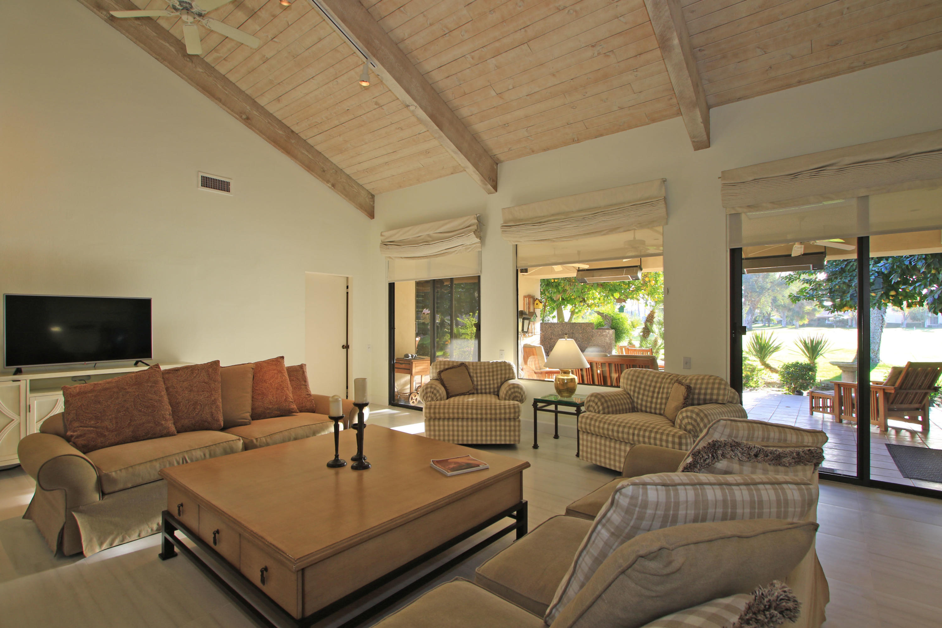 913 Inverness Drive Rancho Mirage, CA 92270 - Photo 11 of 52 a living room with furniture and a flat screen tv