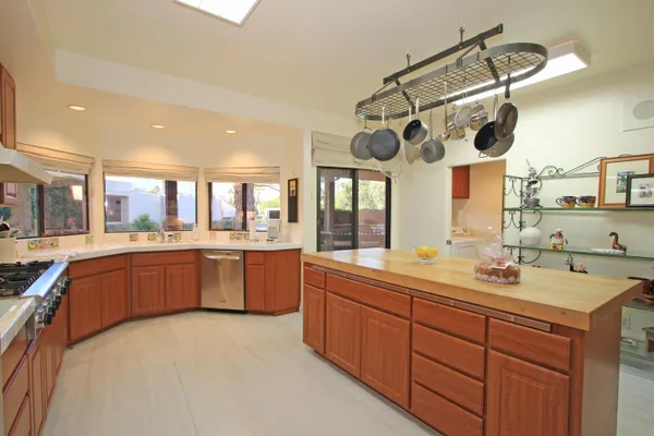a kitchen with stainless steel appliances a sink a stove and cabinets