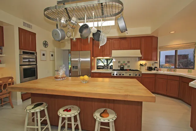 a kitchen with cabinets and wooden floor