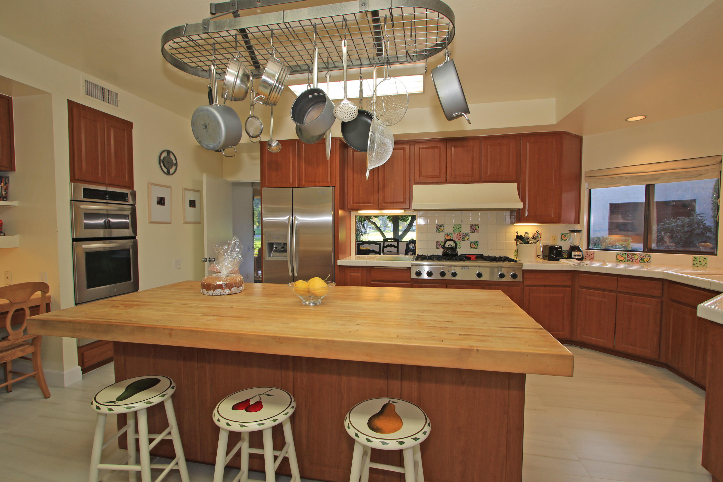 913 Inverness Drive Rancho Mirage, CA 92270 - Photo 16 of 52 a kitchen with cabinets and wooden floor