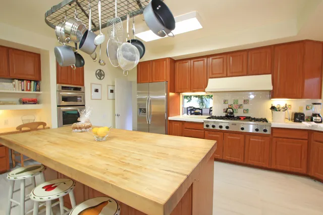 a kitchen with stainless steel appliances granite countertop a sink dishwasher and cabinets with wooden floor