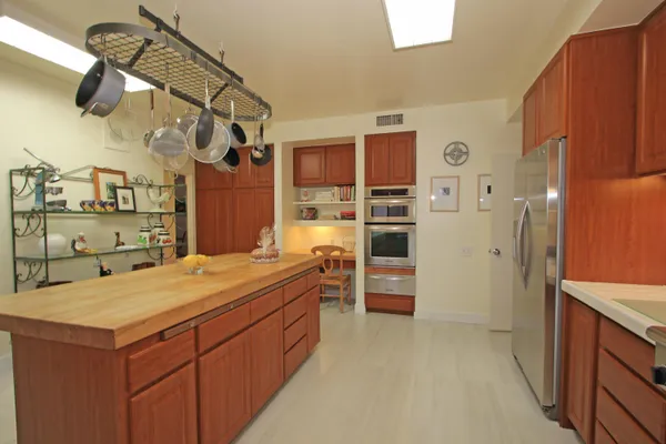 a room with a wooden cabinets and washing machine