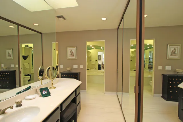 a large kitchen with a table chairs refrigerator and cabinets