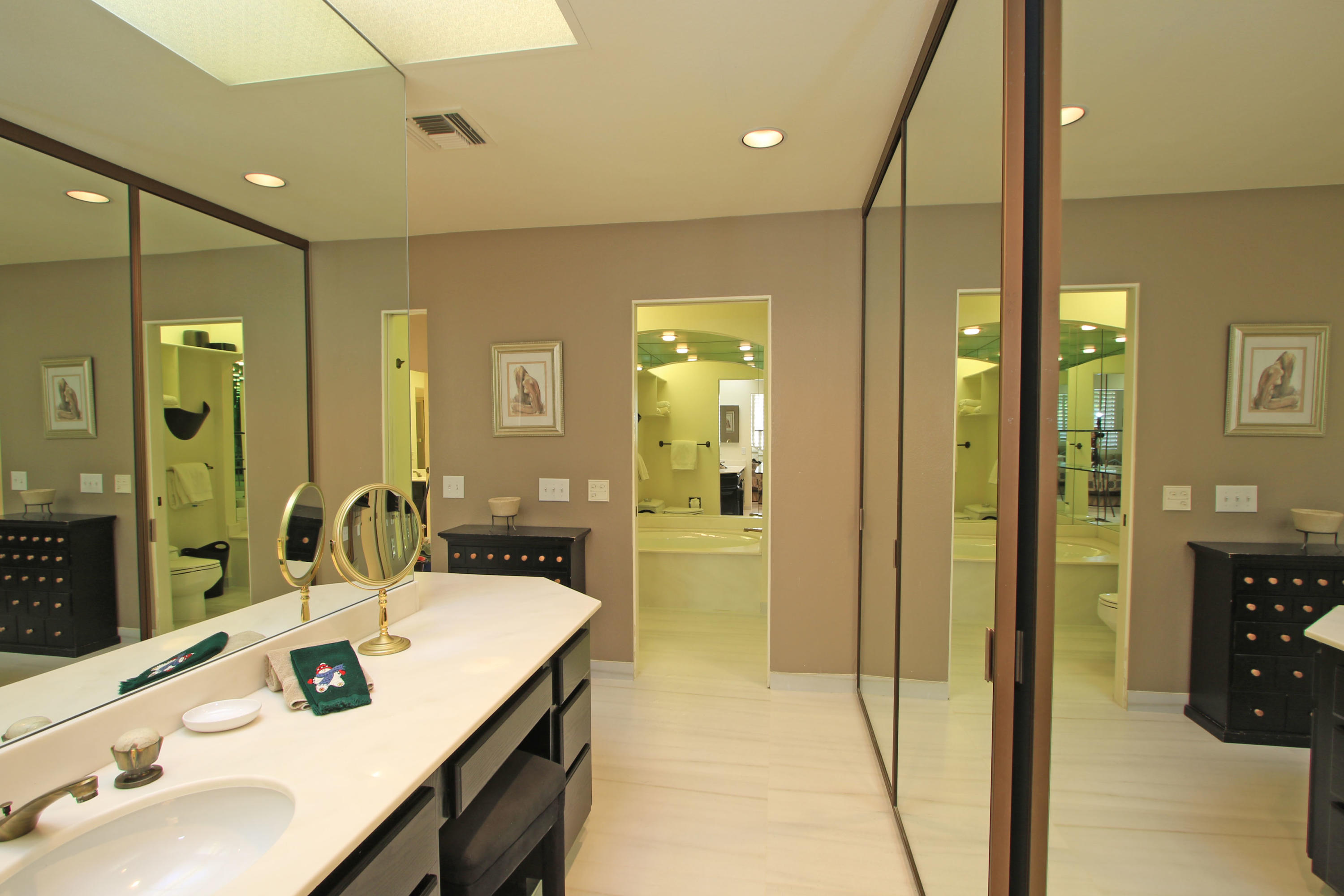 913 Inverness Drive Rancho Mirage, CA 92270 - Photo 27 of 52 a bathroom with a sink and a mirror