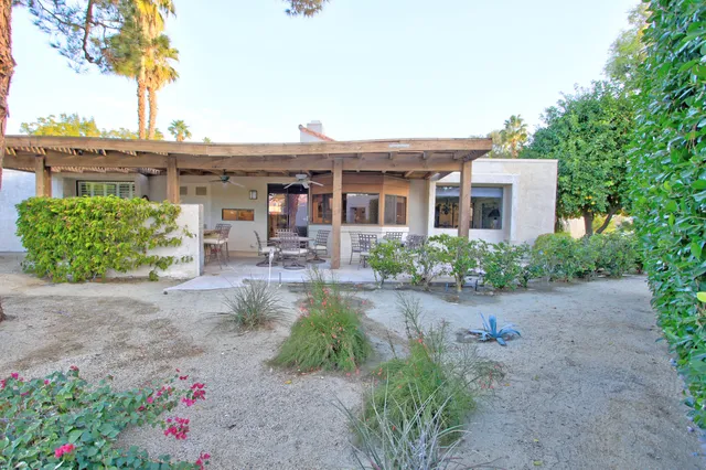 a view of an outdoor dining space with a table and chairs