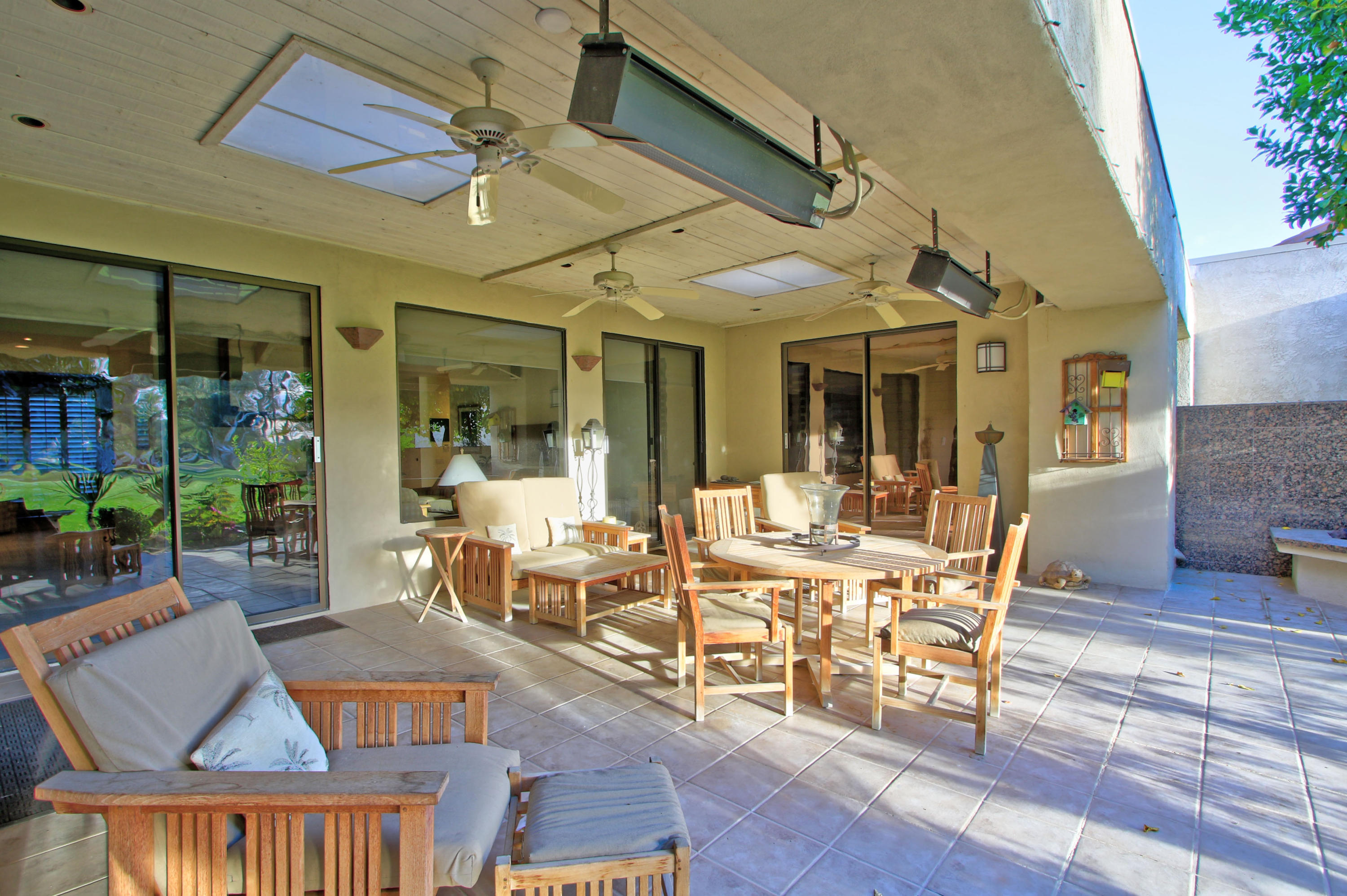 913 Inverness Drive Rancho Mirage, CA 92270 - Photo 41 of 52 a view of a patio with dining table and chairs