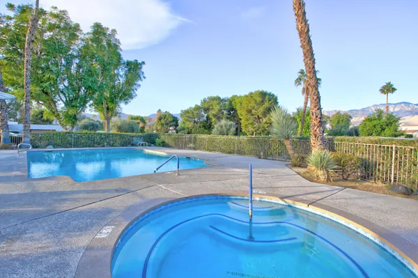 a view of a swimming pool with a lake from a chair