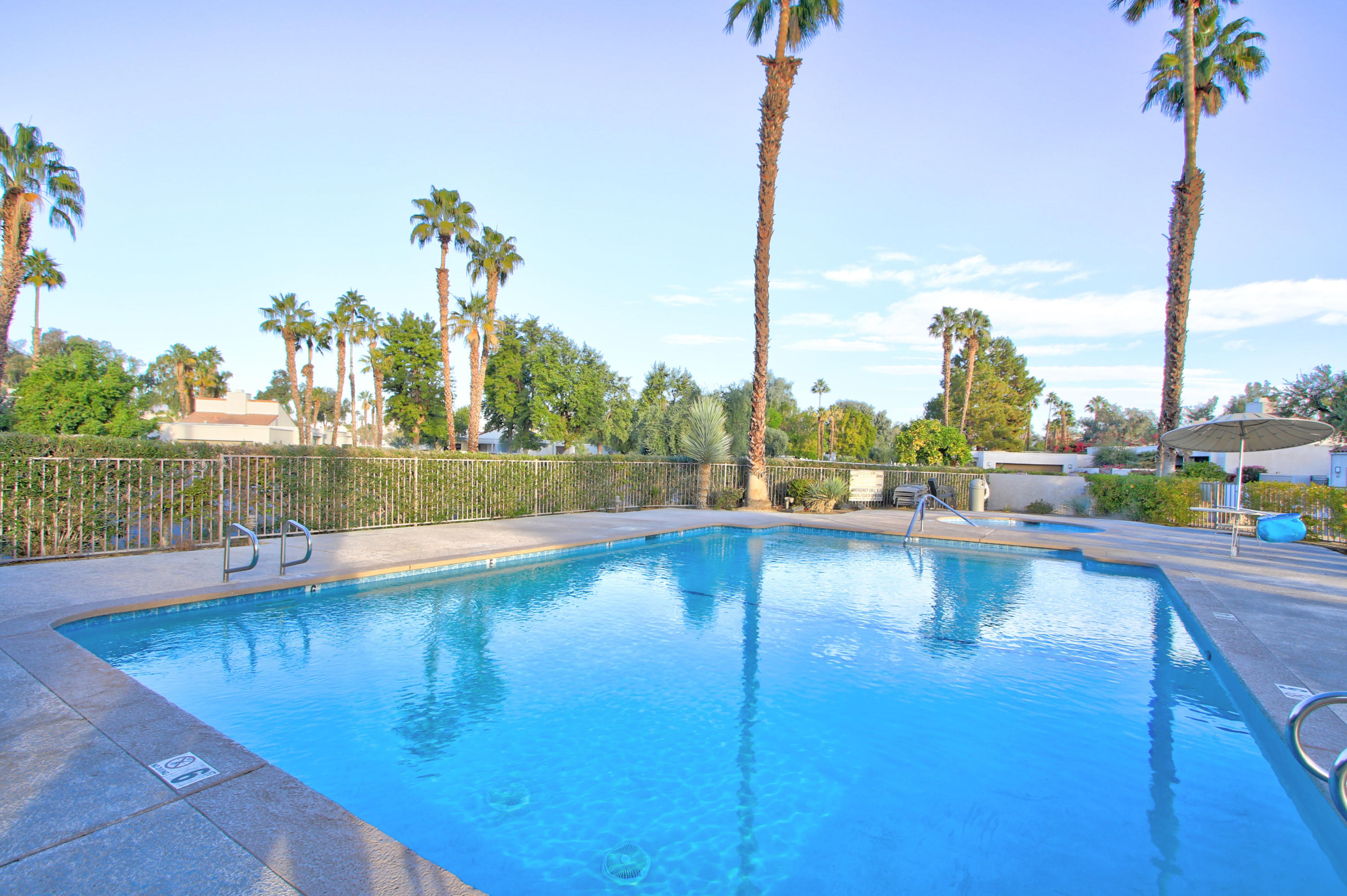 913 Inverness Drive Rancho Mirage, CA 92270 - Photo 50 of 52 a view of a swimming pool with a lake from a chair
