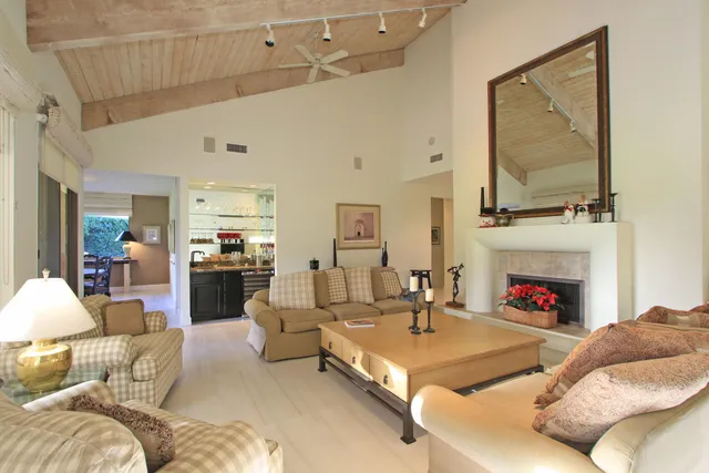 a living room with furniture fireplace and flat screen tv