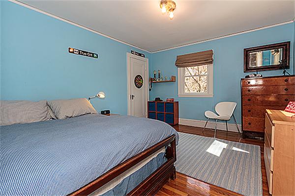 35 Middle Street Lexington, MA 02421 - Photo 10 of 14 a bedroom with a bed and dresser with wooden floor