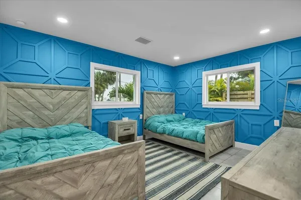 a bed sitting in a bedroom next to a window