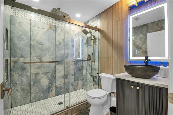 a bathroom with a double vanity sink a toilet and a mirror