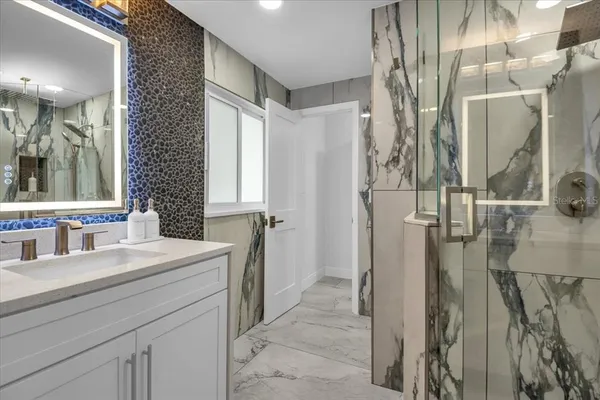 a bathroom with a sink toilet and shower