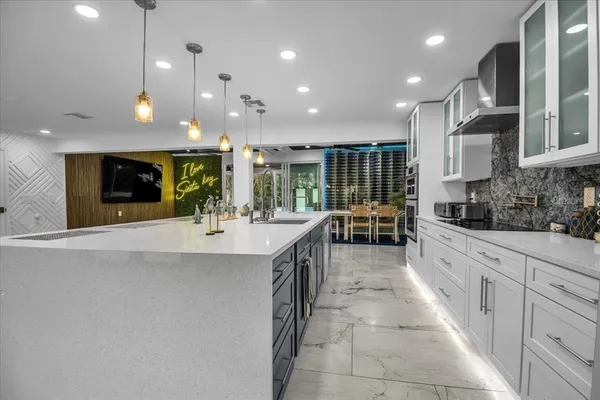 a kitchen with stainless steel appliances kitchen island granite countertop a stove a sink and a microwave