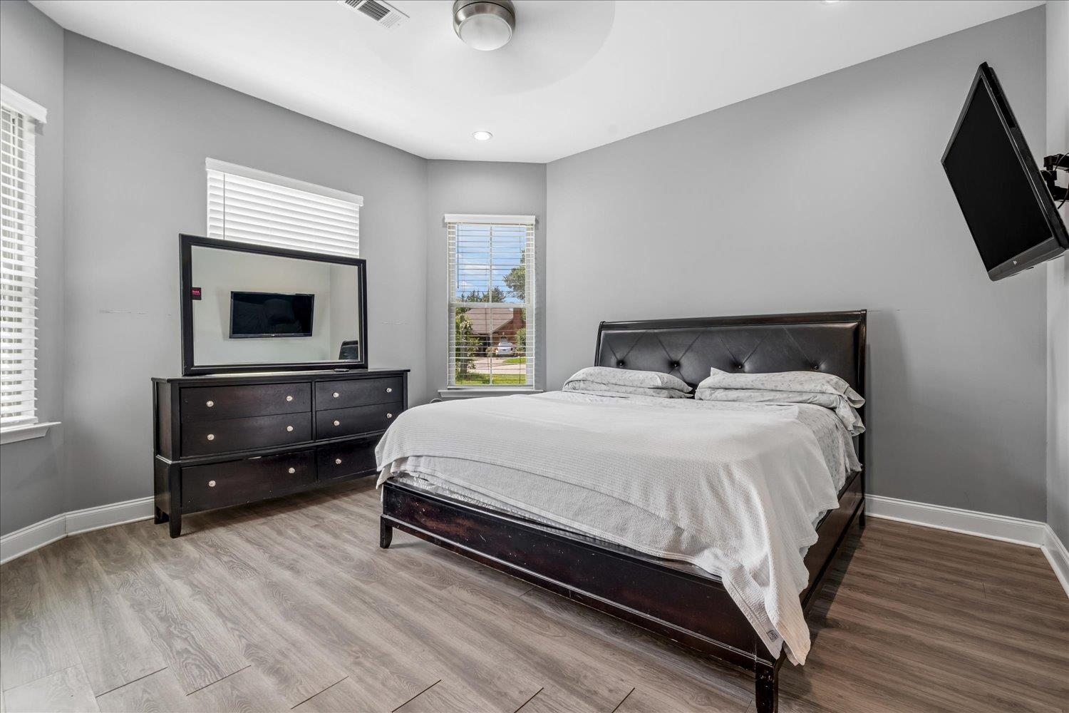 8867 Hampton Court Road East Memphis, TN 38016 - Photo 13 of 23 Bedroom featuring light wood-finish flooring, light gray walls, and white baseboards