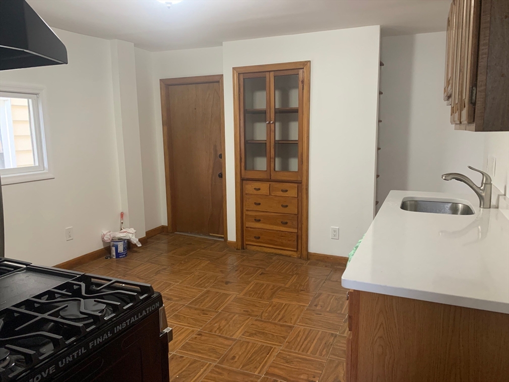 110-112 South Common Street, Unit 2 Lynn, MA 01902 - Photo 2 of 14 a kitchen with a stove and a sink
