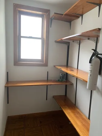 a view of storage and utility room with window