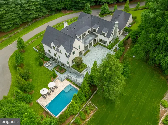 a view of a hallway with bathroom and sink