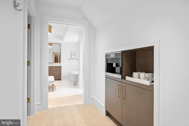 a spacious bedroom with a bed and a chandelier