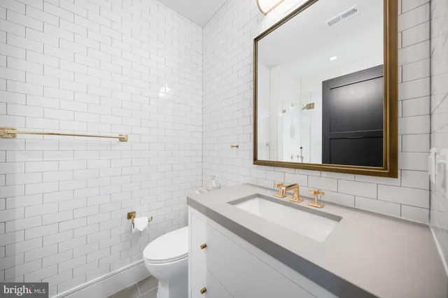 a living room with furniture a fireplace and kitchen view