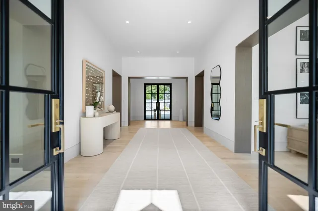 a view of an entryway with wooden floor and door