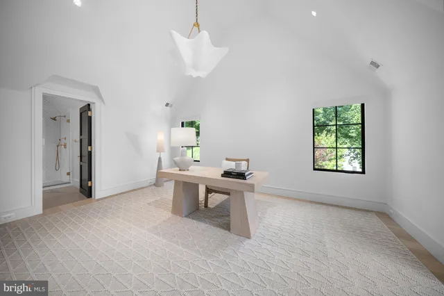 a living room with furniture gym equipment and a large window