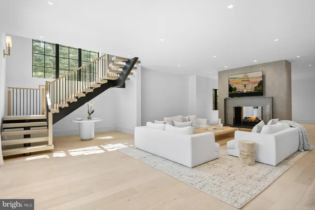 a spacious bedroom with a large bed and a chandelier