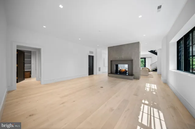 a view of swimming pool with seating area and trees in the background