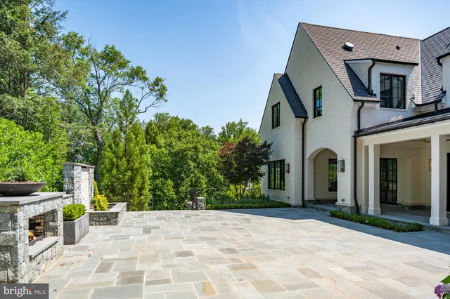 a view of a patio with a table and chairs under an umbrella