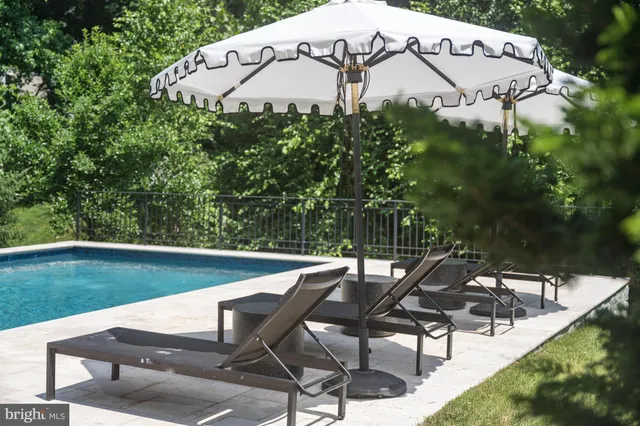 an aerial view of a house with yard swimming pool and outdoor seating