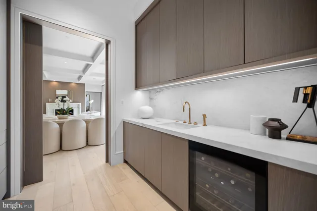 a kitchen with a dining table chairs and wooden floor