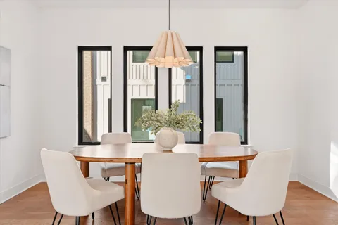 a living room with furniture and large windows