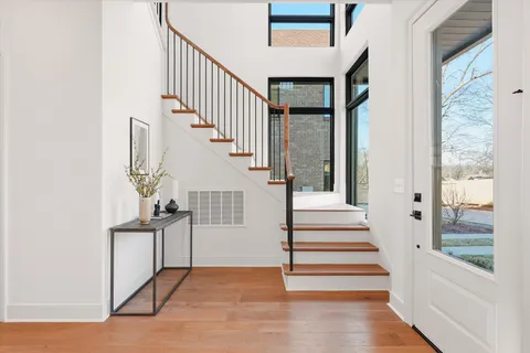 a view of entryway and hall with wooden floor