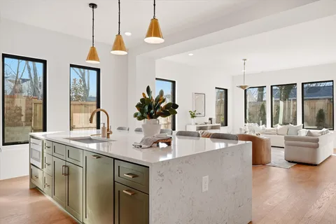 a kitchen with stainless steel appliances granite countertop a sink stove and cabinets