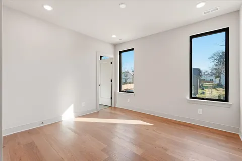 a bathroom with a granite countertop sink a toilet and a bathtub