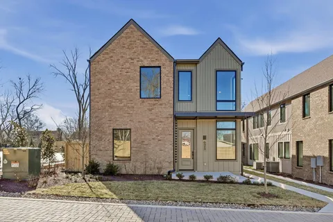 a view of a street with potted plants